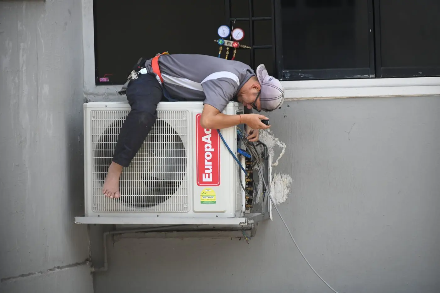 Professional installing an air conditioning unit