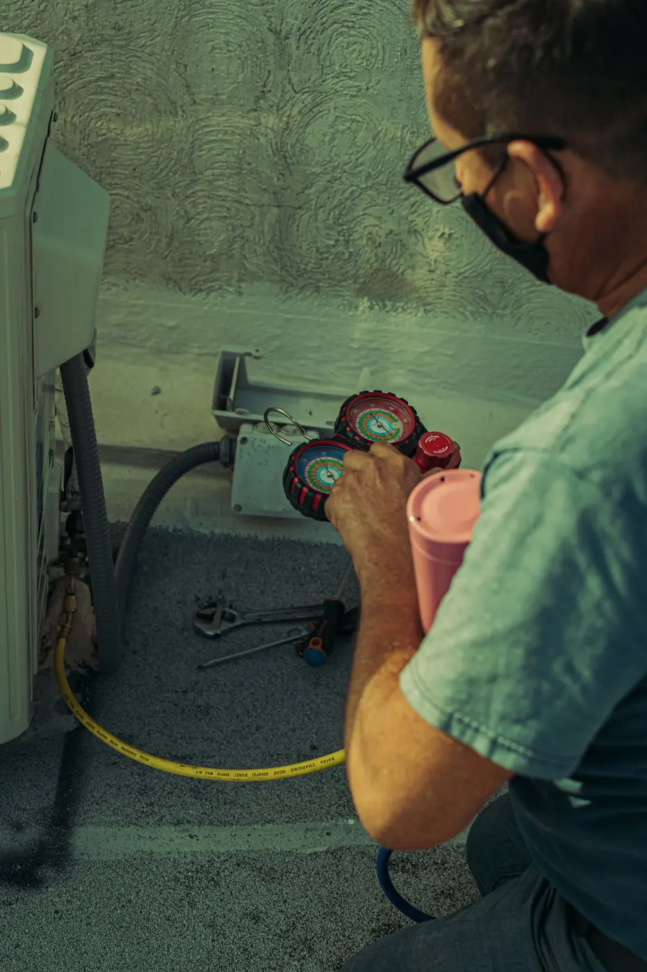 Technician carrying out preventive AC maintenance