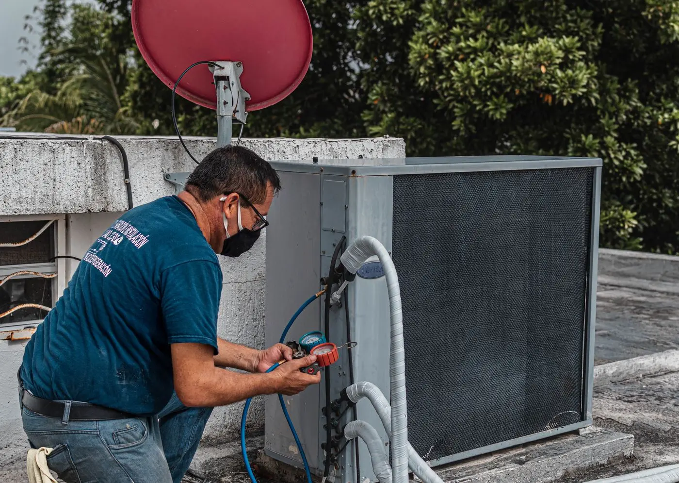 HVAC technician diagnosing an air conditioner during a repair visit